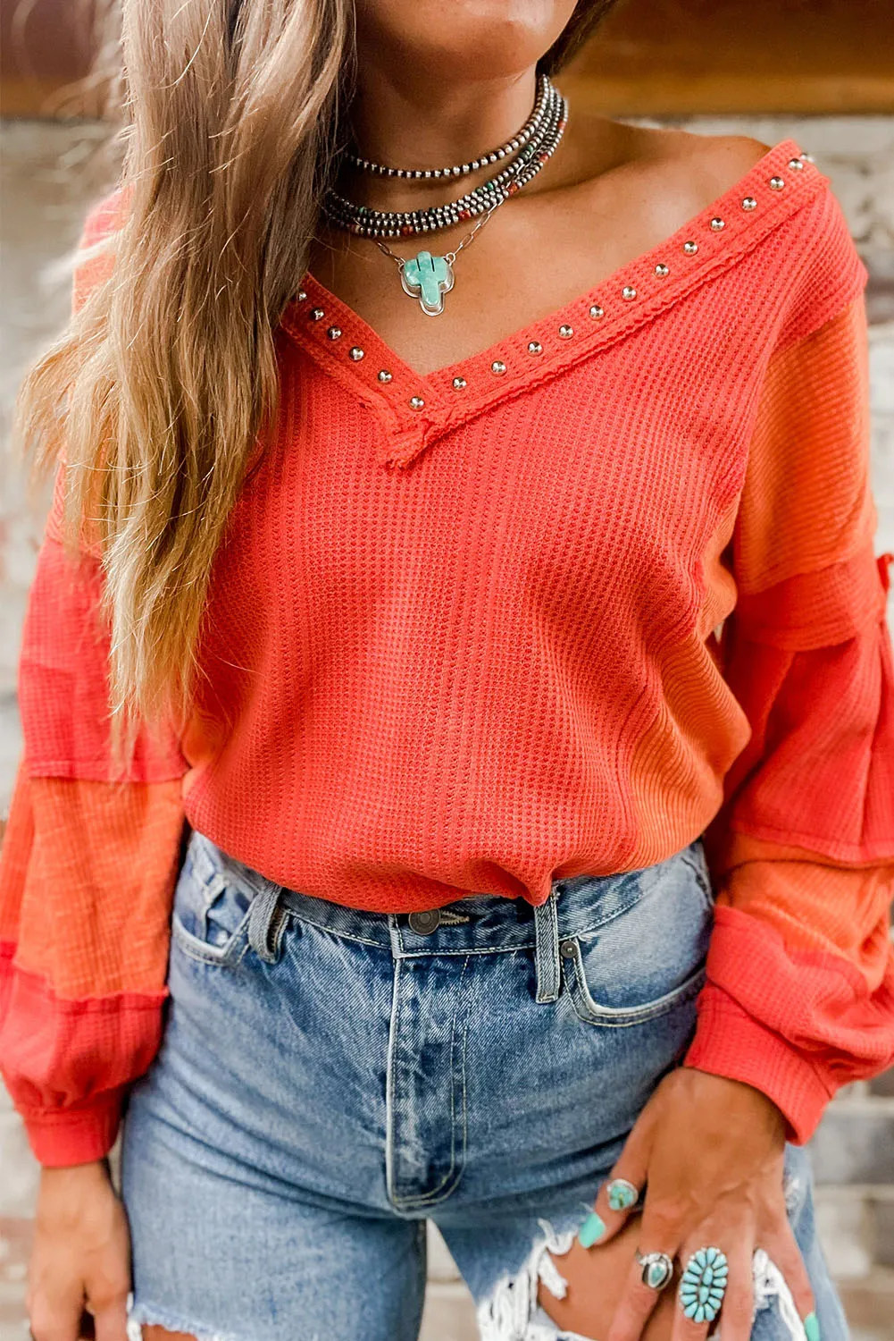 Fiery Red Studded V Neckline Exposed Seam Textured Knit Top